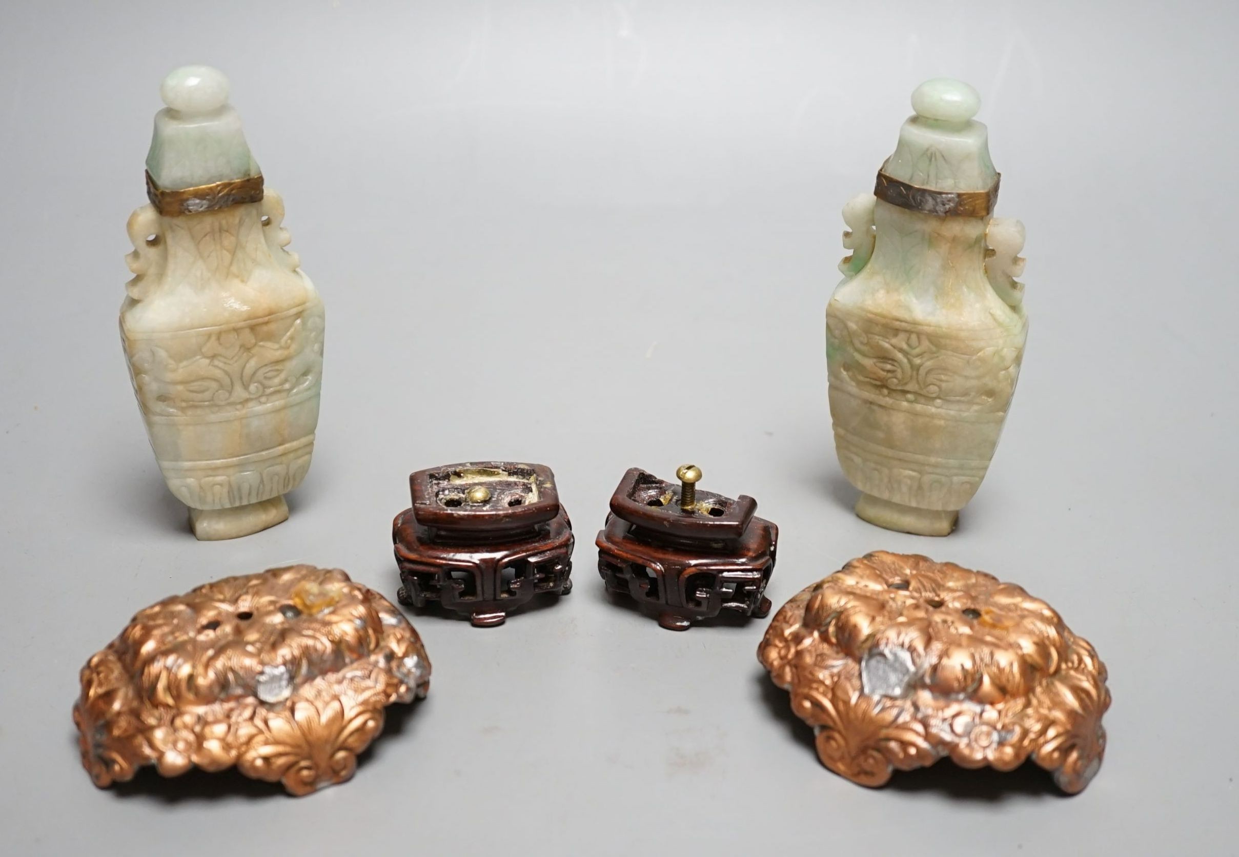 A pair of Chinese jadeite carved vases and covers